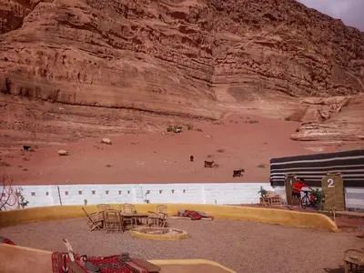 a view of a desert with tables and chairs at MalakoRum in El Quweira
