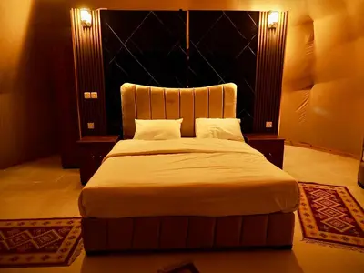 a bedroom with a large bed with a large headboard at Wadi Rum experience in Wadi Rum