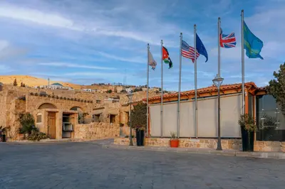 a group of flags on top of a building at The Old Village Hotel & Resort in Wadi Musa