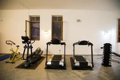 a gym with treadmills and exercise bikes in a room at The Old Village Hotel & Resort in Wadi Musa