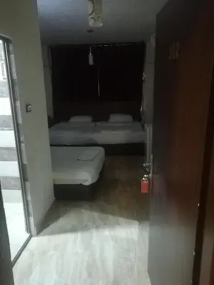 a small room with a bed and a window at Al-Houriat Hotel in Amman