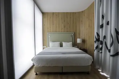 a bedroom with a bed and a large window at La Locanda Boutique Hotel in Amman