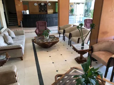 a living room with couches and chairs and a table at Dweik Hotel 2 in Aqaba