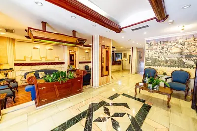 a living room with a couch and a table and chairs at Comfort Hotel Suites in Amman