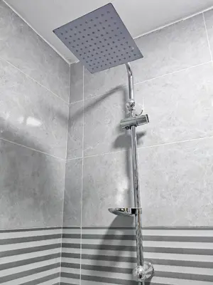 a shower with a shower head in a bathroom at Petra Gate Hotel in Wadi Musa