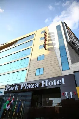 a hotel with a sign on the front of a building at Spark Plaza Hotel in Amman
