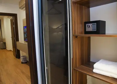 a glass closet with a clock on a shelf at Spark Plaza Hotel in Amman