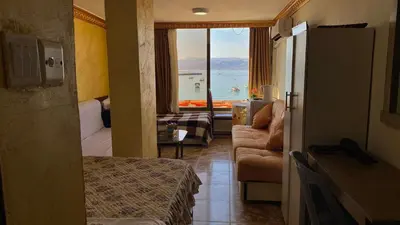 a hotel room with a view of the ocean at Al-Amer Aqaba Beach Hostel in Aqaba