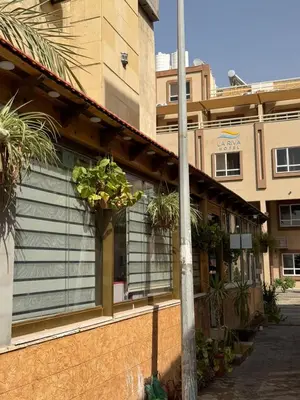 a building with a window with plants on it at Al-Amer Aqaba Beach Hostel in Aqaba