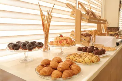 a buffet of different types of pastries on a table at Lacosta Hotel in Aqaba