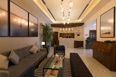 a living room with a couch and a table at The Conroy Boutique Hotel in Amman