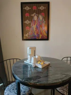 a table with a coffee maker on top of it at The Conroy Boutique Hotel in Amman