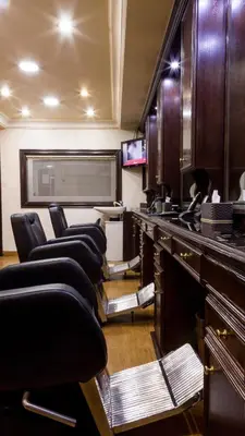 a salon with a row of chairs in a room at Aghadeer Hotel in Amman