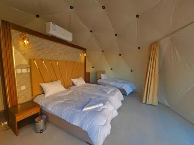 a bedroom with two beds in a tent at Salman Zwaidh Camp in Wadi Rum