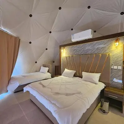 a bedroom with two beds in a tent at Salman Zwaidh Camp in Wadi Rum