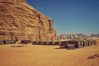 a building in the desert next to a mountain at Salman Zwaidh Camp in Wadi Rum