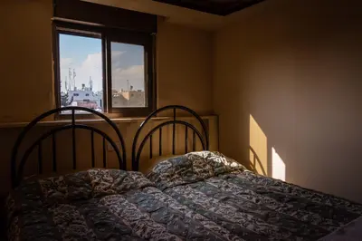 a bedroom with a bed with a blanket on it at Madaba Hotel in Madaba