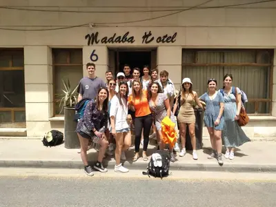 a group of people standing in front of a building at Madaba Hotel in Madaba