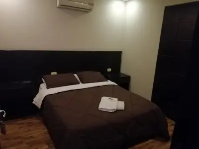 a bedroom with a large bed with two towels on it at Madaba Hotel in Madaba
