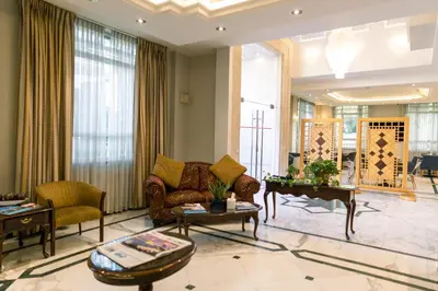 a living room with a couch and a table at Kindi Suite Hotel in Amman