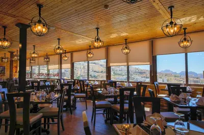 a dining room with tables and chairs and lights at Town Season Hotel in Wadi Musa