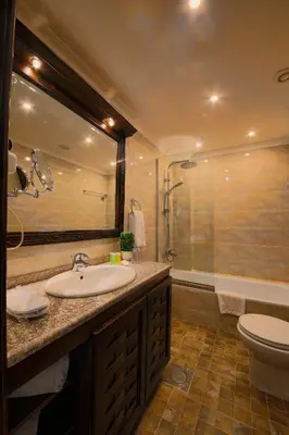 a bathroom with a sink and a toilet and a shower at Town Season Hotel in Wadi Musa
