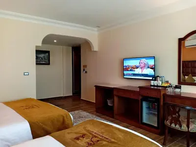 a hotel room with a bed and a flat screen tv at Town Season Hotel in Wadi Musa