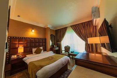 a hotel room with a bed and a desk at Town Season Hotel in Wadi Musa