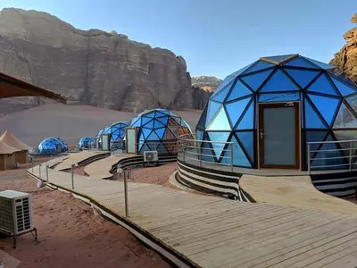 a group of blue domes in the desert at Memories Aicha Luxury Camp in Wadi Rum