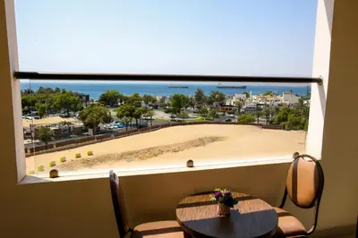 a window with a table and a view of a beach at Mina Hotel in Aqaba