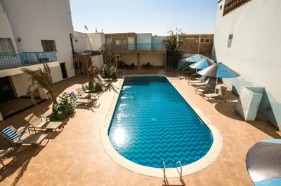 an overhead view of a swimming pool in a building at Mina Hotel in Aqaba