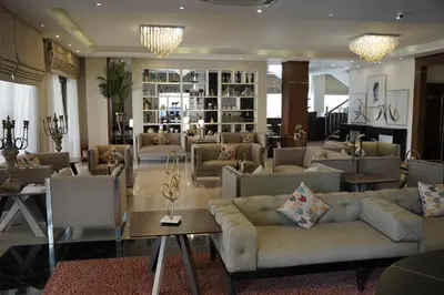 a living room with couches and tables in a lobby at Lijam Hotel in Amman