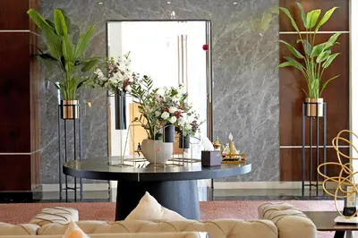 a round table with flowers on it in a room at Lijam Hotel in Amman