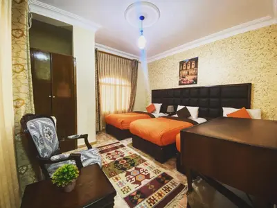 a hotel room with a bed and a desk and a desk at Anbat Midtown Hotel in Wadi Musa