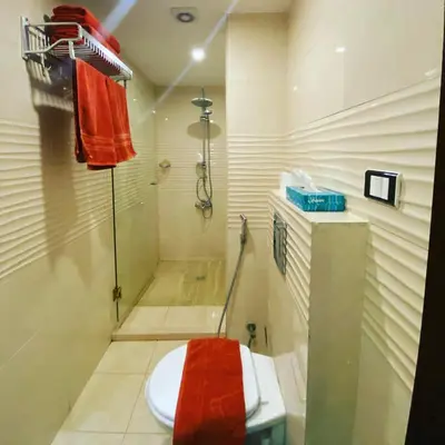 a bathroom with a shower and a toilet in it at Anbat Midtown Hotel in Wadi Musa