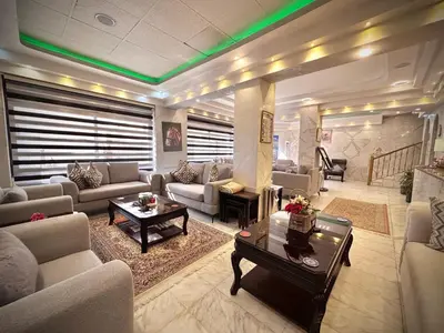 a large living room with couches and a table at Anbat Midtown Hotel in Wadi Musa