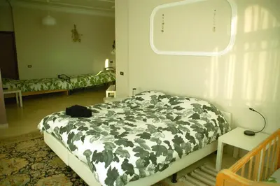 a bedroom with a bed with a black and white comforter at B&B Petra Fig Tree Villa in Wadi Musa