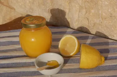 a jar of orange juice and a lemon on a table at B&B Petra Fig Tree Villa in Wadi Musa
