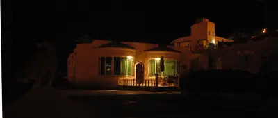 a house at night with its lights on at B&B Petra Fig Tree Villa in Wadi Musa