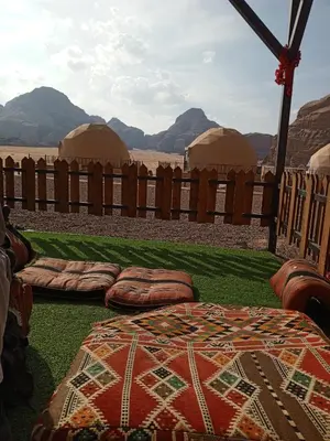 a bedroom with two domes and a bed in the grass at Jamal Rum desert in Wadi Rum