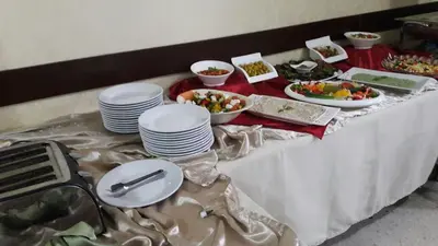 a table with plates and bowls of food on it at Pilgrim's Guest House in Madaba