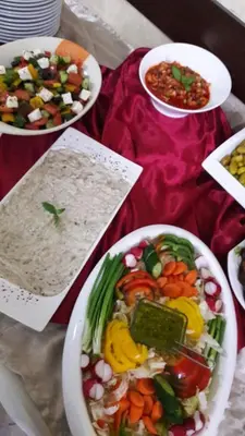 a table with plates of food and bowls of rice at Pilgrim's Guest House in Madaba