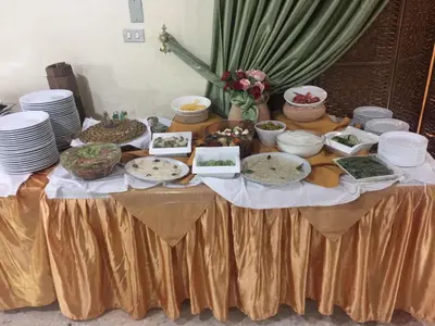 a table with plates and bowls of food on it at Pilgrim's Guest House in Madaba
