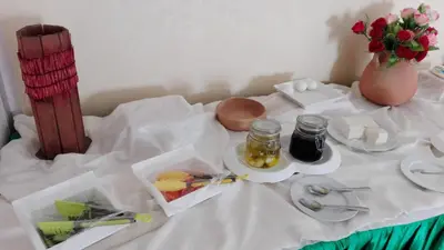 a table with a plate of food and a vase with flowers at Pilgrim's Guest House in Madaba