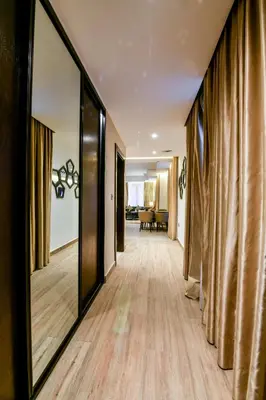 a hallway with a large mirror and a living room at Downtown Hotel Apartments in Amman