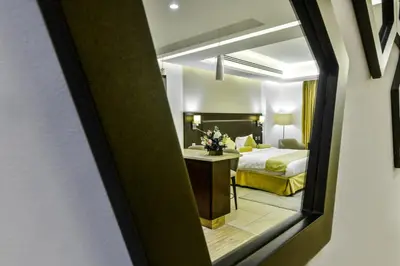 a hotel room with a bed and a mirror at Downtown Hotel Apartments in Amman