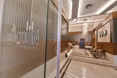 a lobby of a building with a sign on the wall at Downtown Hotel Apartments in Amman