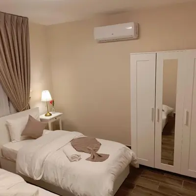 a bedroom with a bed and a air conditioner at The Boutique Hotel Amman in Amman