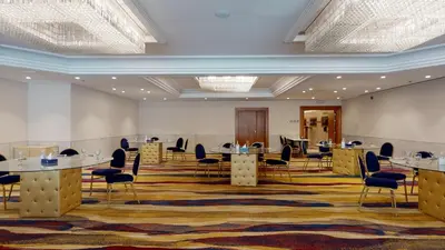 a large meeting room with tables and chairs at Ayass Hotel in Amman