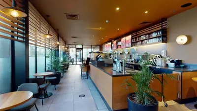 a restaurant with a bar and tables and chairs at Ayass Hotel in Amman